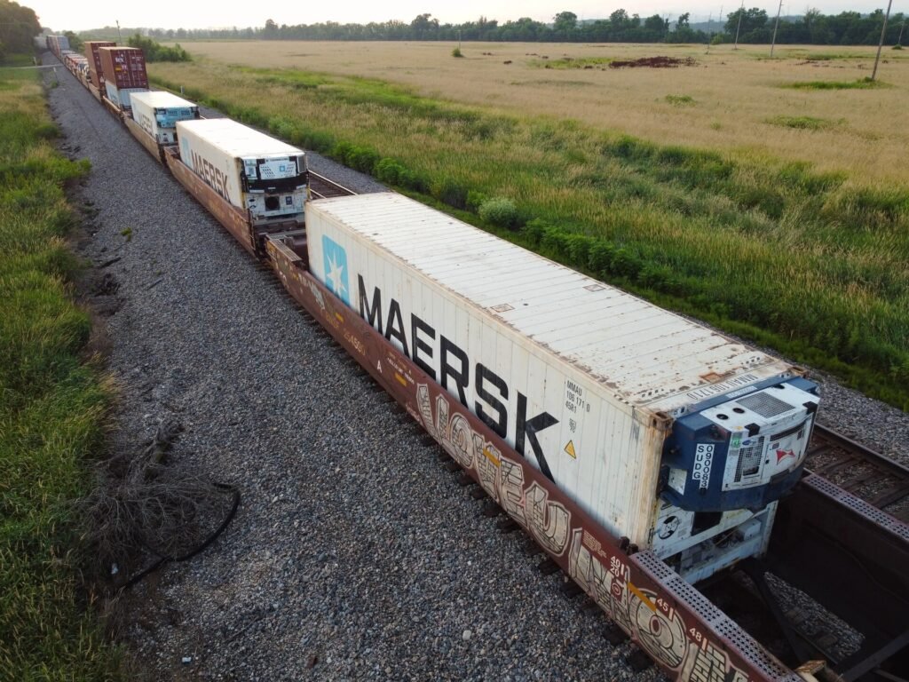 Refrigerated reefer containers being moved by freight train