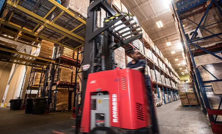 Forklift moving through a distribution warehouse