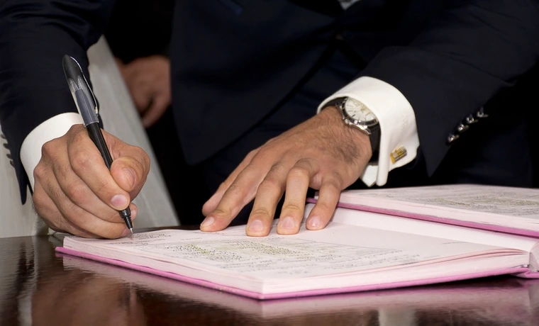 Businessman signing trade documents