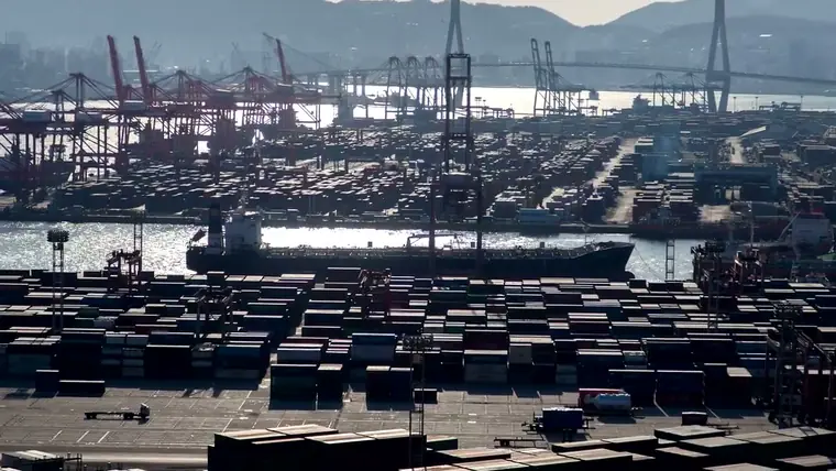 Rows of stacked shipping containers at a port terminal