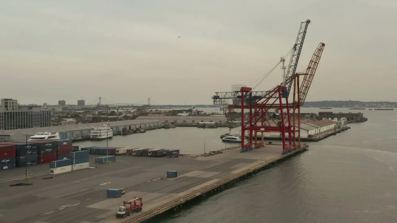 Red port crane on the quayside of a container terminal