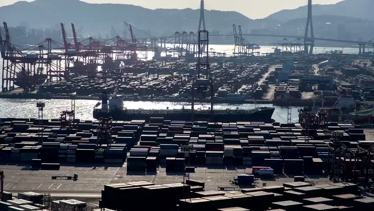 Container terminal with stacked containers and a vessel