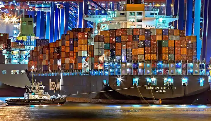 Containers stacked on a ship at Burchardkai terminal, Hamburg, at night